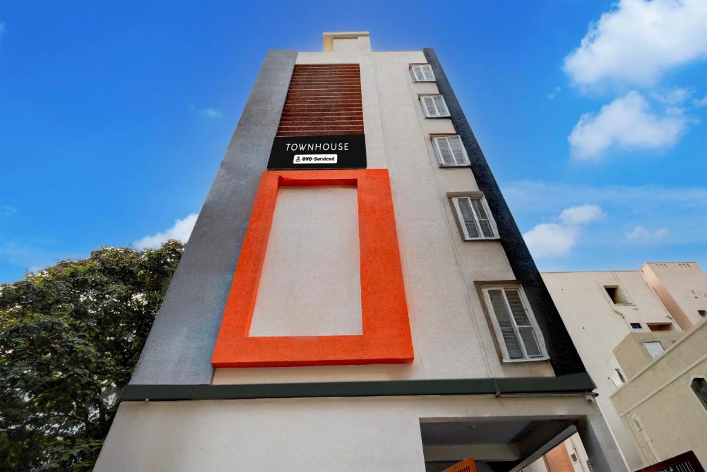 a tall building with a staircase on the side of it at Super Townhouse Telapur Junction Formerly Fortune Inn in Hyderabad