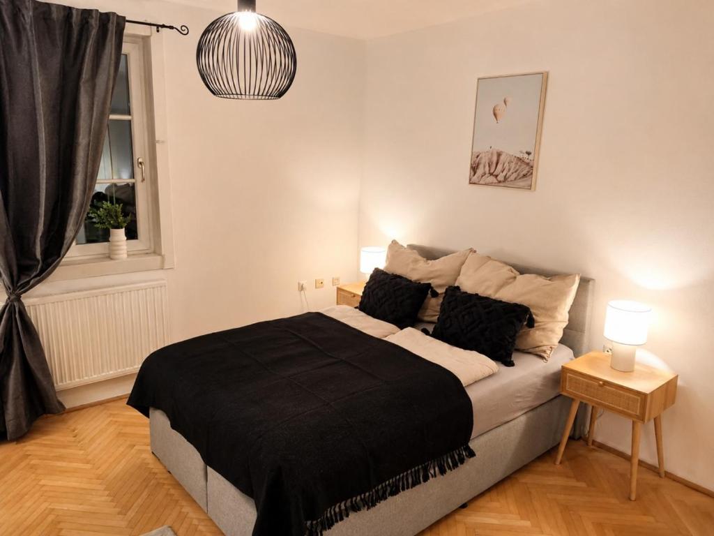 a bedroom with a large bed with a black blanket at Faraway Homes Studio Enns #14 in Enns