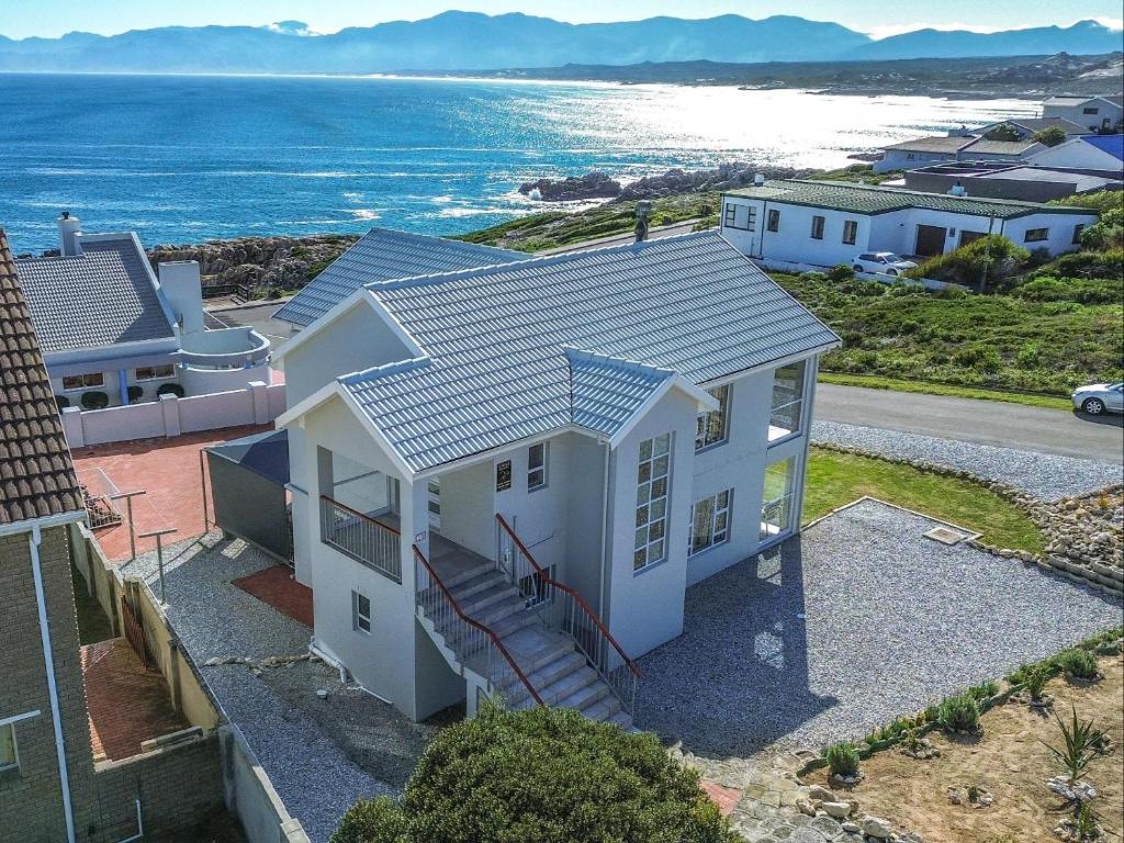 an aerial view of a house with the ocean at Bluemist Accommodation in Gansbaai