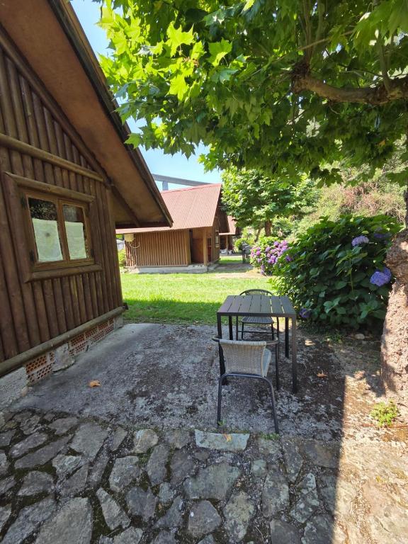 a bench sitting in front of a house at camping los pradones in Cudillero
