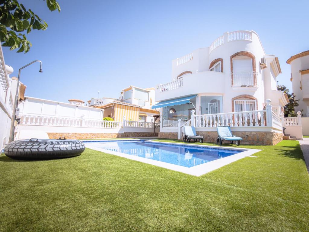 a house with a yard with a swimming pool at Luxury Private Pool Villa Campoverde in Pinar de Campoverde