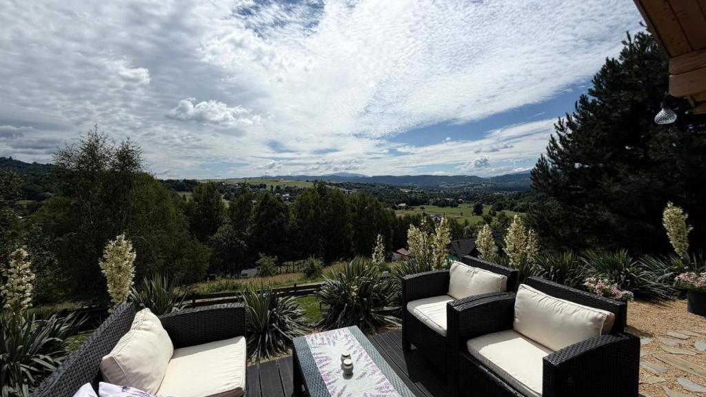 a patio with couches and a table with a view at Babia Góra View House in Kocierz Moszczanicki