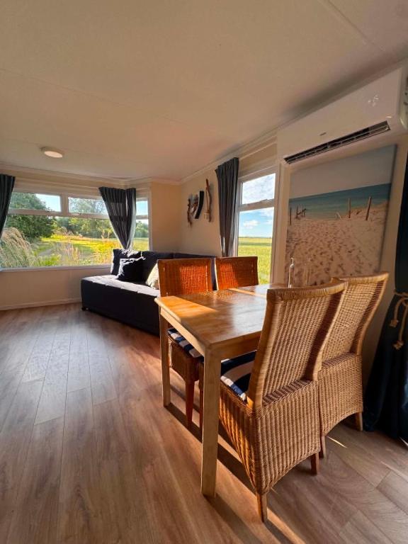 a living room with a table and chairs and a bed at Między polami in Drewnica