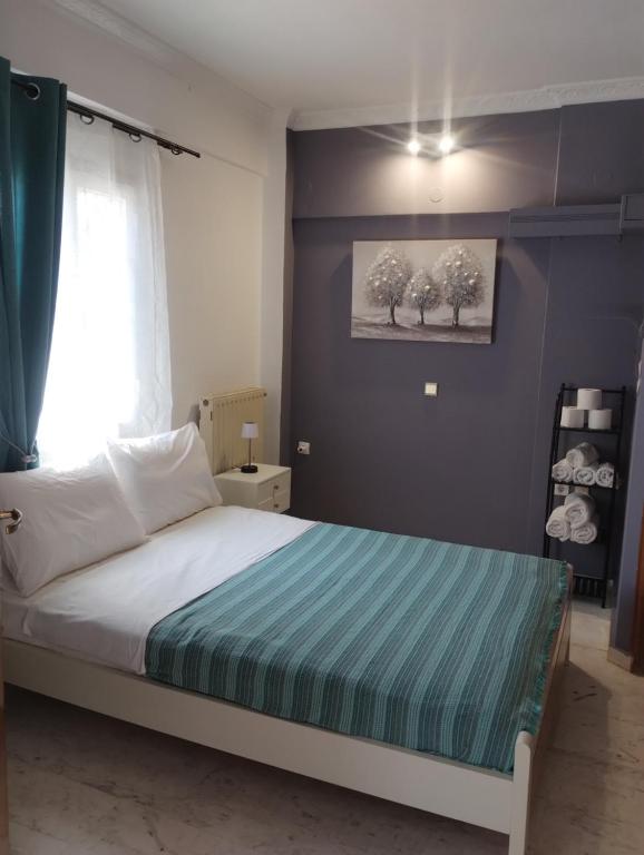 a bedroom with a bed with a blue wall at Αλέξανδρος 3 in Myrina