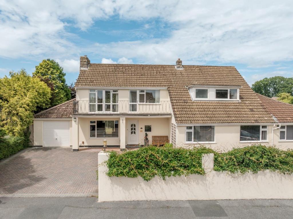 a white house with a brown roof at Talbot House by Grandeur Property in Bournemouth