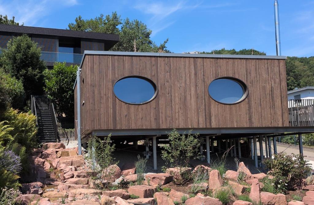 a house with two circular windows on the side of it at Exklusive Ferienlodge in Wertheim