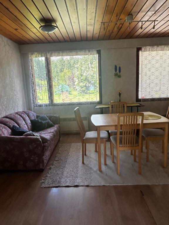 a living room with a couch and a table and chairs at Martan Porti Three-bedroom house in Imatra