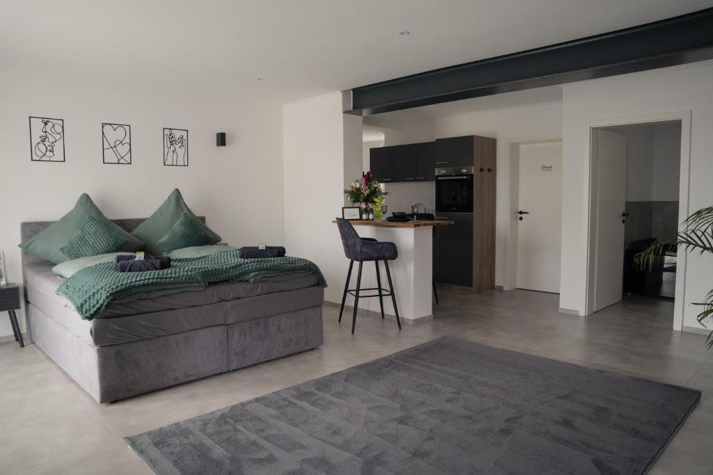 a living room with a couch and a kitchen at Ferienwohnung Eifelmomente in Rittersdorf