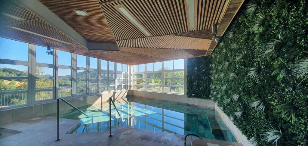an overhead view of a swimming pool in a building at L'Eden du Forez in Le Brugeron