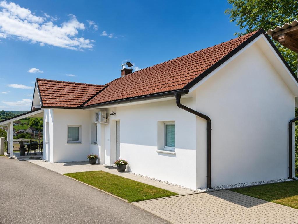 a white house with a red roof at Vinea Apartma in Gornja Radgona