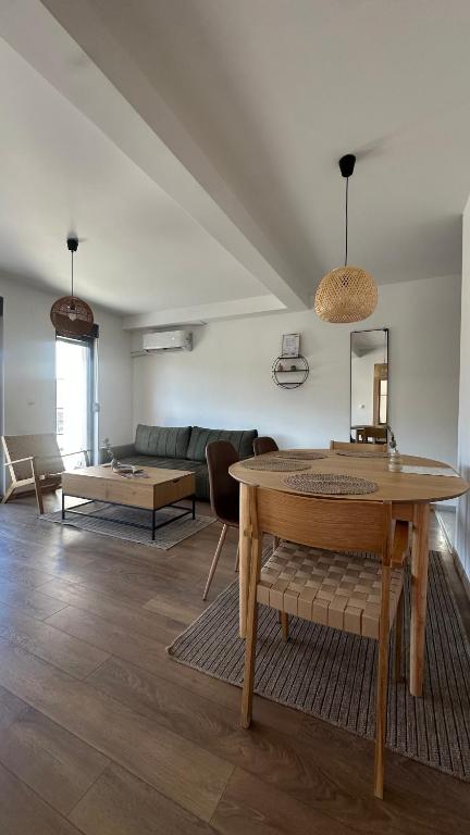 a living room with a table and a couch at Eirene Residence in Vrnjačka Banja