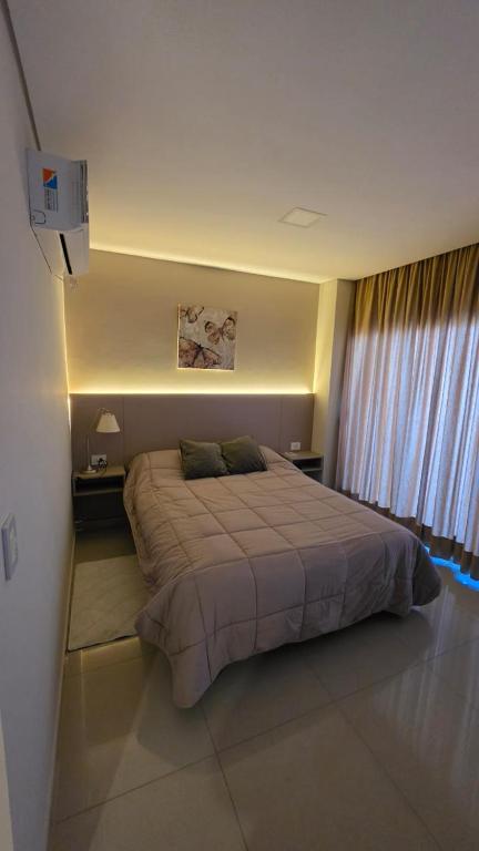 a bedroom with a large bed in a room at TORRE GUAYASAMIN in Corrientes