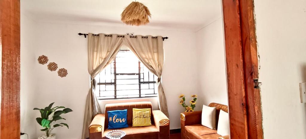 a living room with a chair and a window at Dans place in Moshi