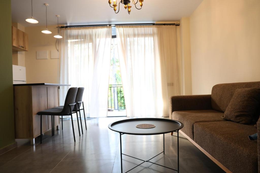 a living room with a couch and a table at Newly Renovated 10 Min To Center in Gomi