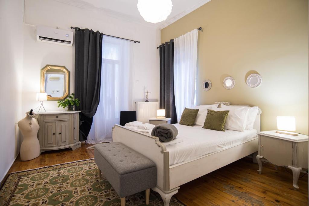 a bedroom with a white bed and a mirror at Thalgiron, a breath away from Delphi in Ámfissa