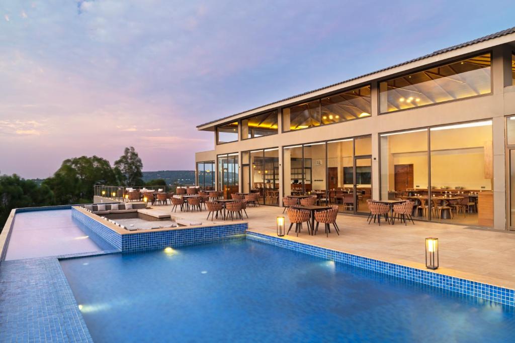 an exterior view of a house with a swimming pool at Ayati Resort & Spa in Panchgani