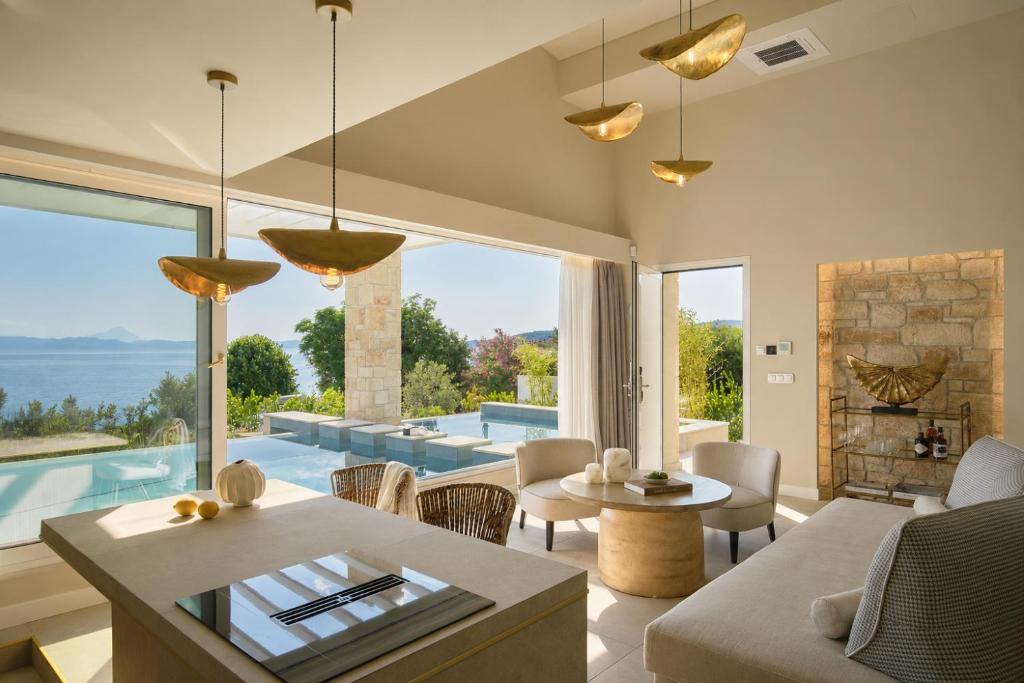 a living room with a view of the ocean at Kappa Resort in Paliouri