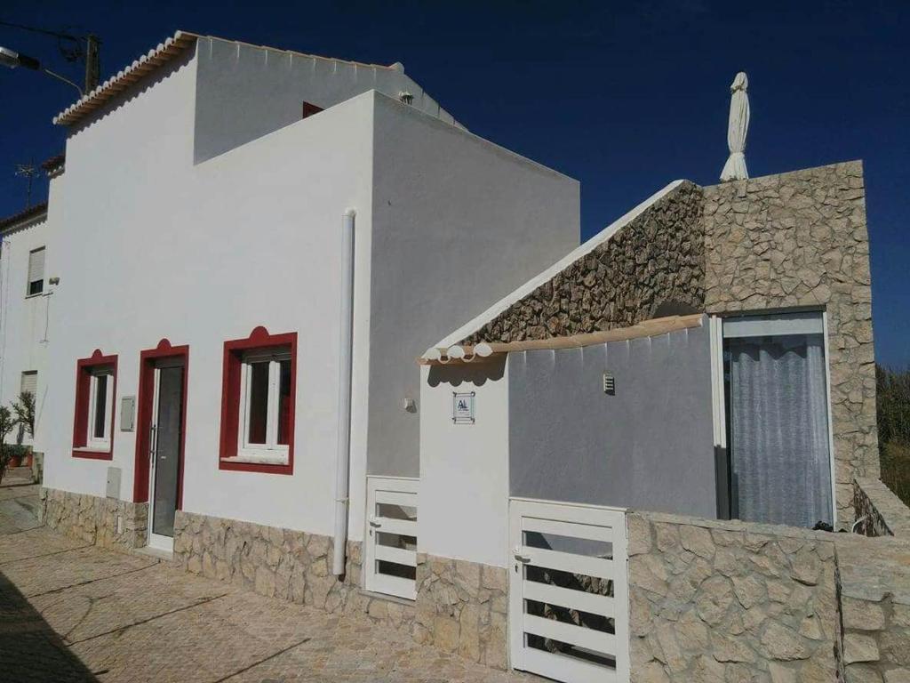 a white building with a bird on top of it at Casa Bela in Sagres