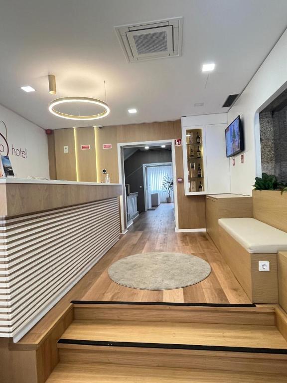 a lobby of an office building with a reception desk at Seculo Hotel in Porto