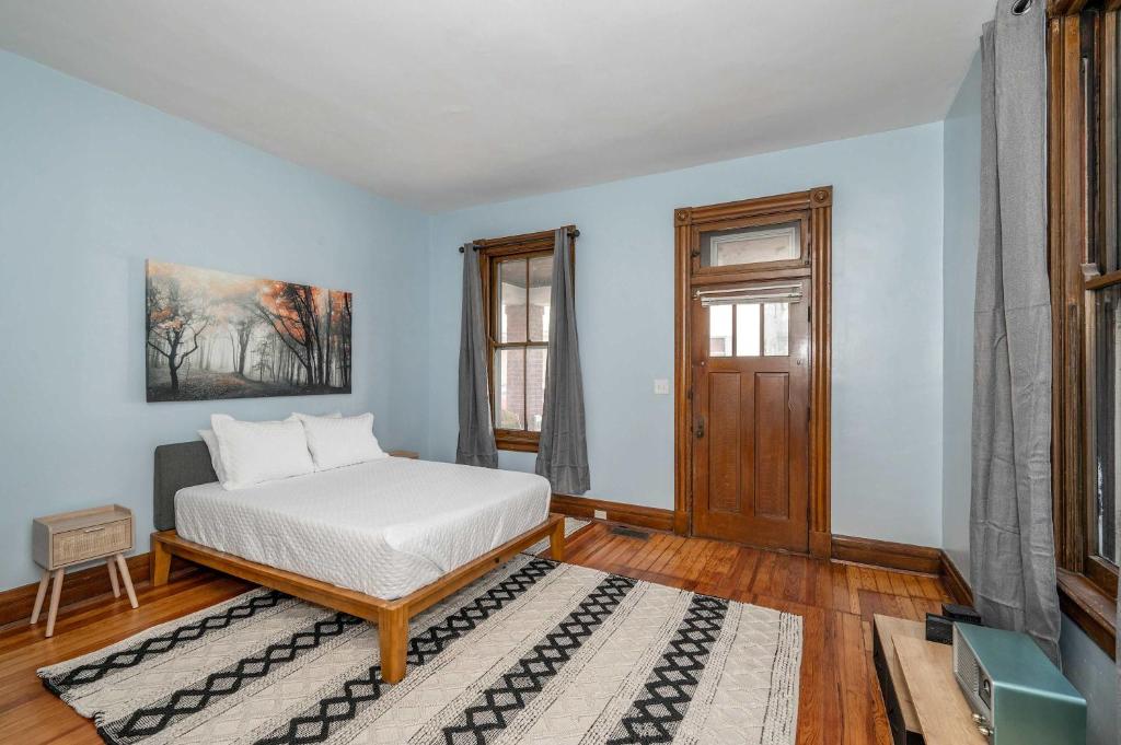 a bedroom with a bed and a window at Historical John H Dickman House in Covington