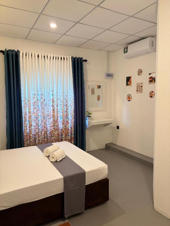 a hospital room with two beds and a window at The Cottage Weligama in Weligama