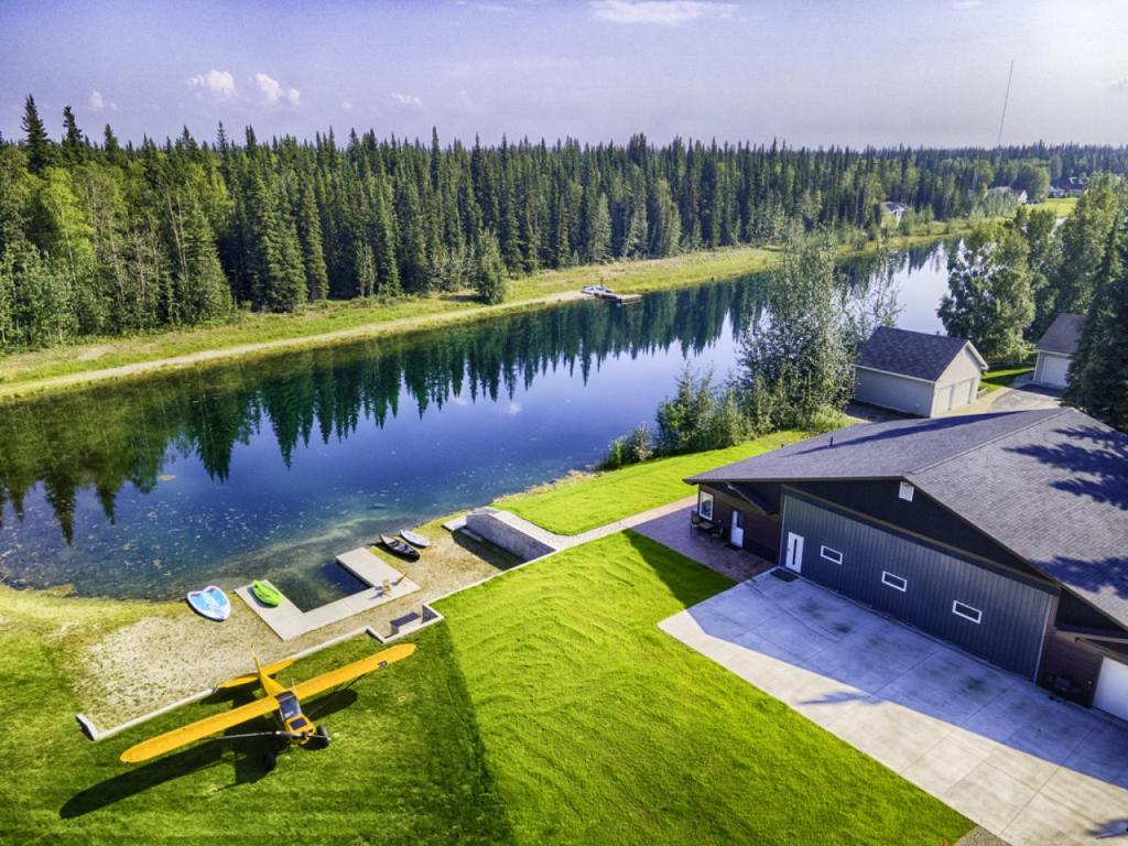 an aerial view of a building next to a lake at Lakefront Aviators Aurora Retreat in North Pole