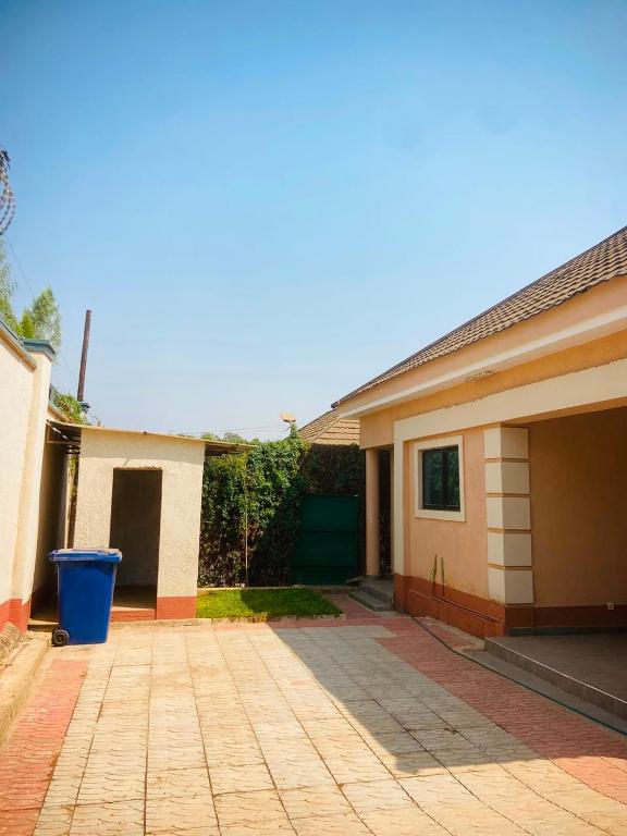 a house with a driveway in front of it at Nehema Appartments in Lubumbashi