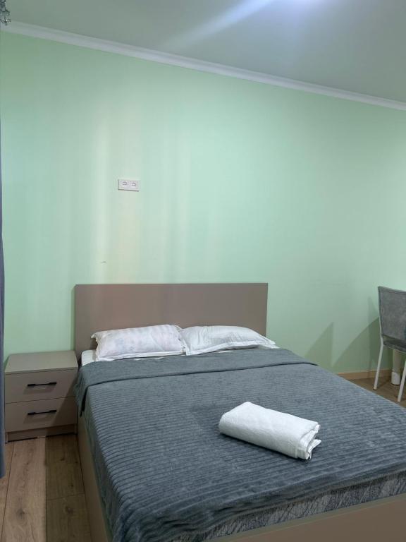 a bed with two white towels on top of it at МилаДэя in Kapchagay
