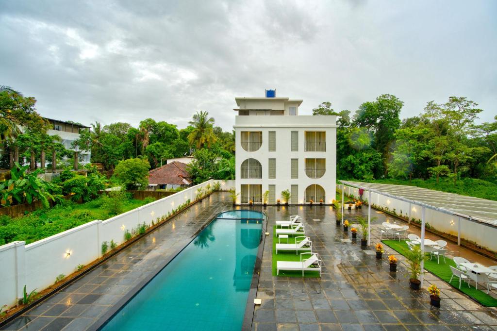 an overhead view of a hotel with a swimming pool at The Goa Courtyard by Forever stays in Arpora