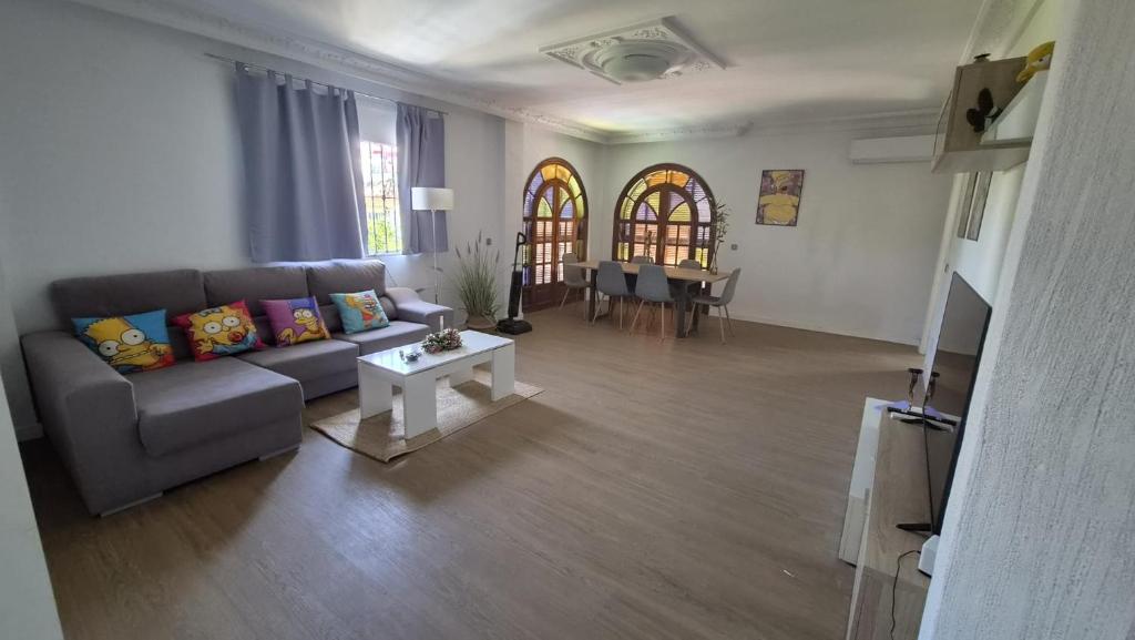 a living room with a couch and a table at The Simpsons in Seville in Mairena del Aljarafe