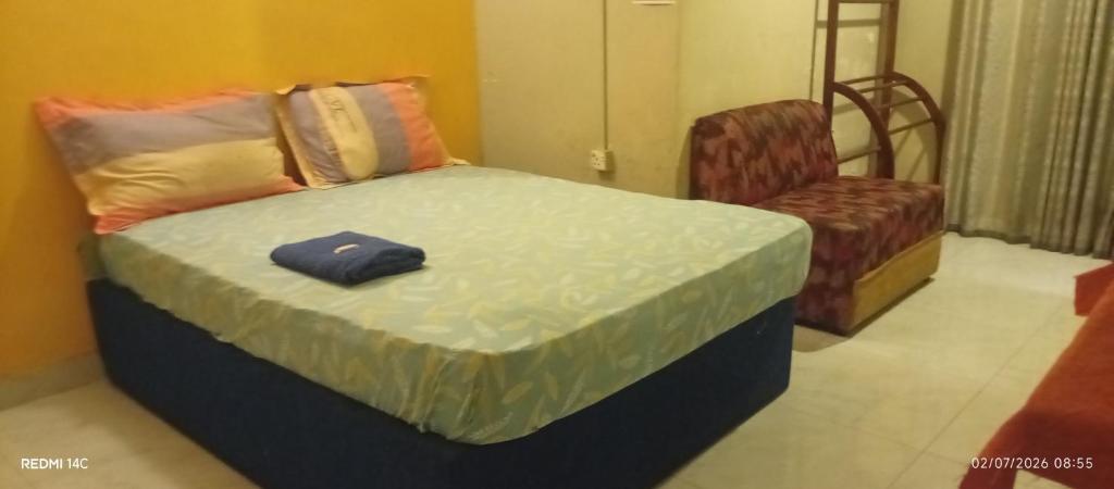 a bed and a chair in a room at Sahansa hotel in Nugegoda