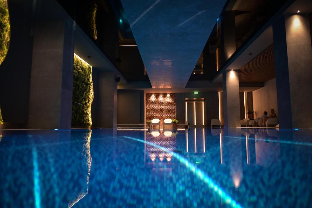 a swimming pool in a hotel at night at Fabesca Boutique Hotel & SPA in Sovata