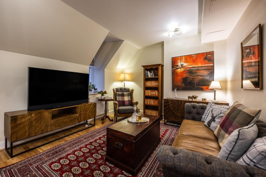 a living room with a large flat screen tv at Moat House 8 Harris Apartment in Fort Augustus