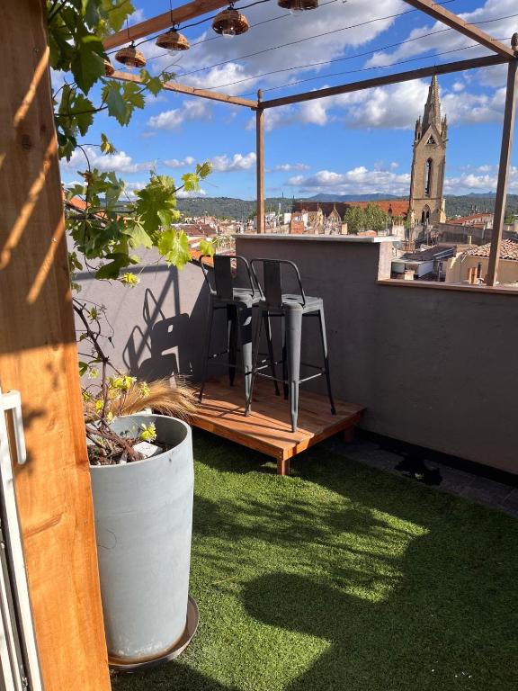 a balcony with chairs and a view of a church at Le petit nid Aixois in Aix-en-Provence