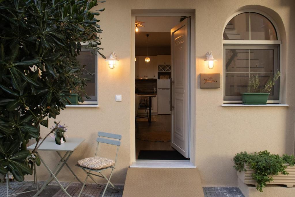 a door leading into a house with a table and chairs at Chryso Boutique Guesthouse in Chrysoupolis