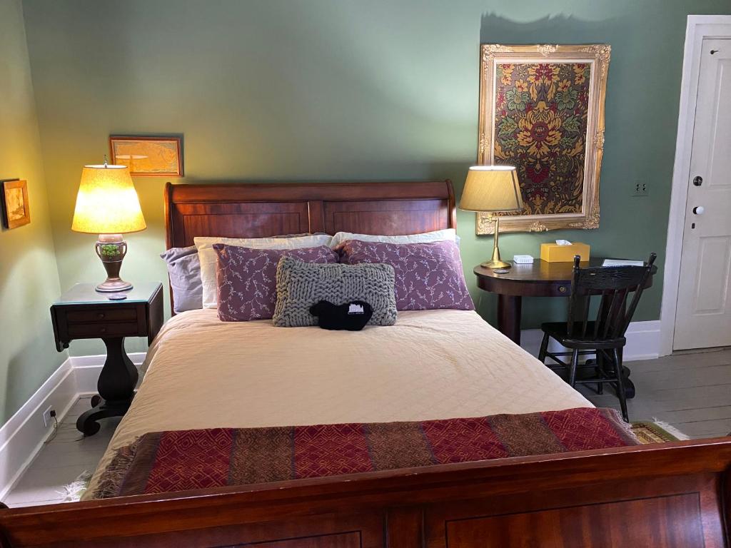 a bedroom with a large bed with two night stands and two lamps at Black Sheep Inn in Hammondsport