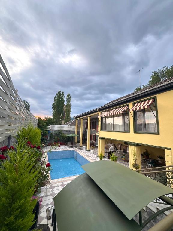 a house with a swimming pool next to a building at Comfort Villa Sheki in Sheki