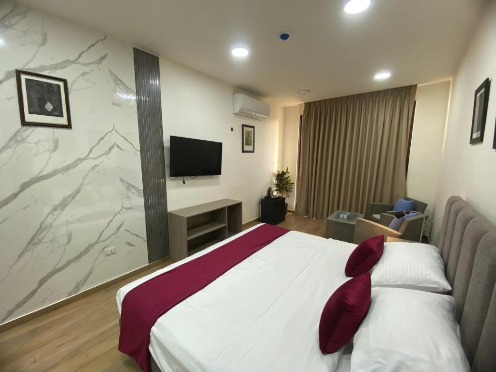 a hotel room with a bed and a television at Sindyan Resort in Al Salt
