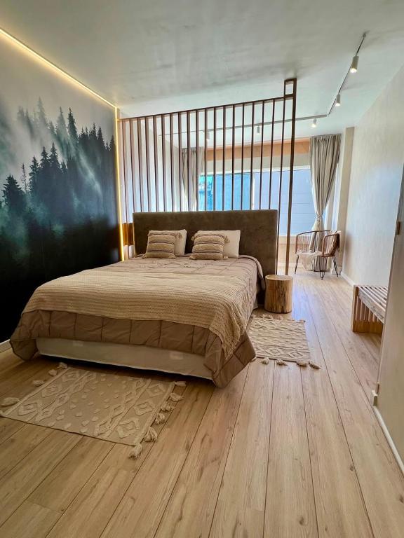 a bedroom with a large bed and a wooden floor at Refugio del Sur in San Carlos de Bariloche