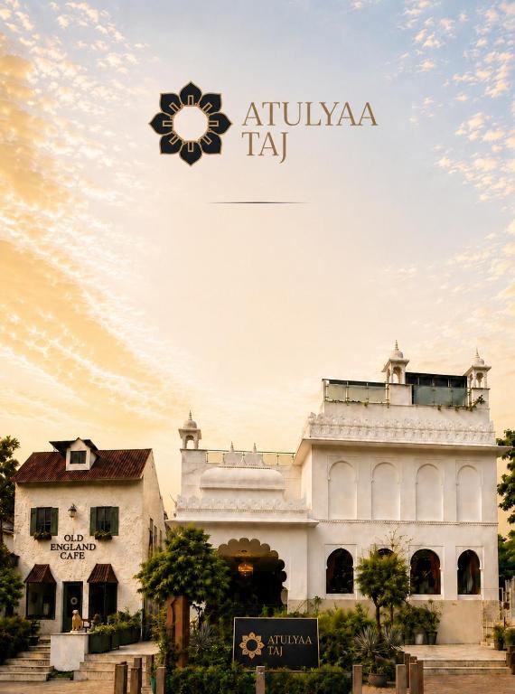 a building with a sign in front of it at Hotel Atulyaa Taj in Agra