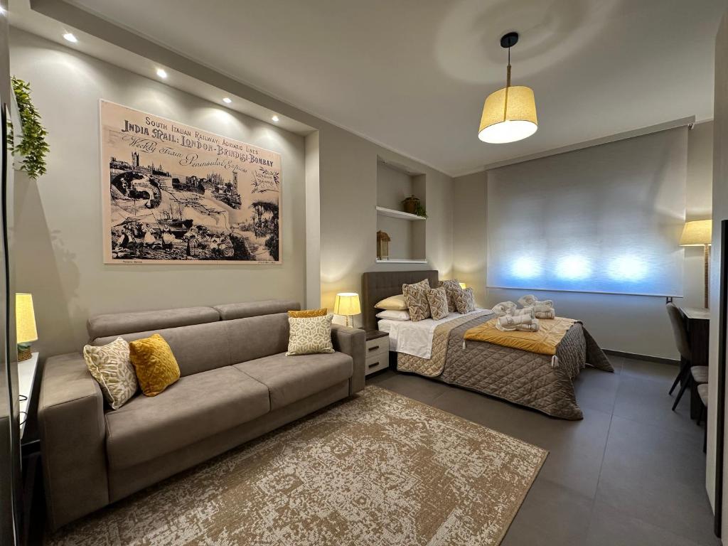 a living room with a couch and a bed at Agorà Connect Space in Brindisi