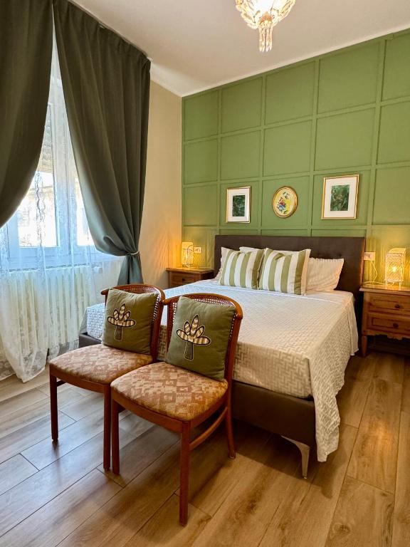 a bedroom with a bed and two chairs in it at Serenity B&B in Brescia