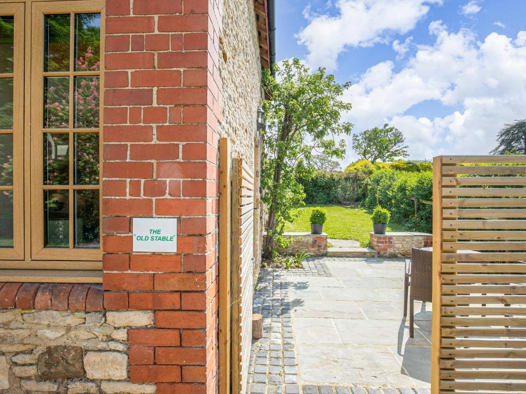 a brick building with a sign on the side of it at The Old Stable in Dursley
