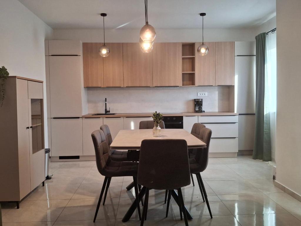 a kitchen with a dining room table and chairs at Adriatic Pearl Povile in Povile
