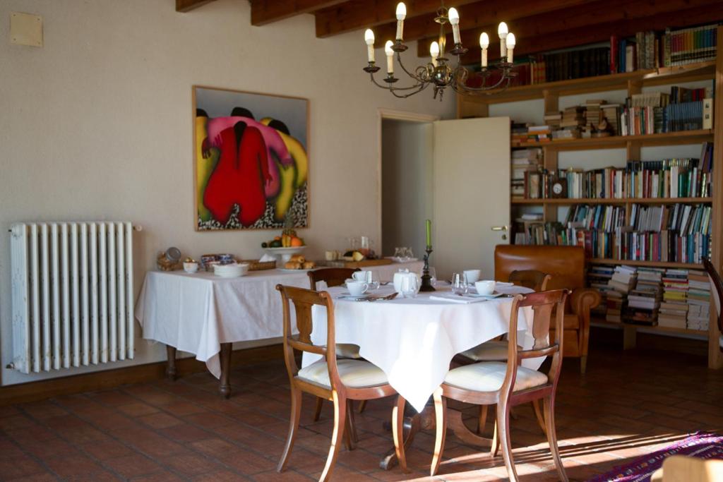 a dining room with a white table and chairs at La Bribaudonnière in Saint-Palais-de-Phiolin