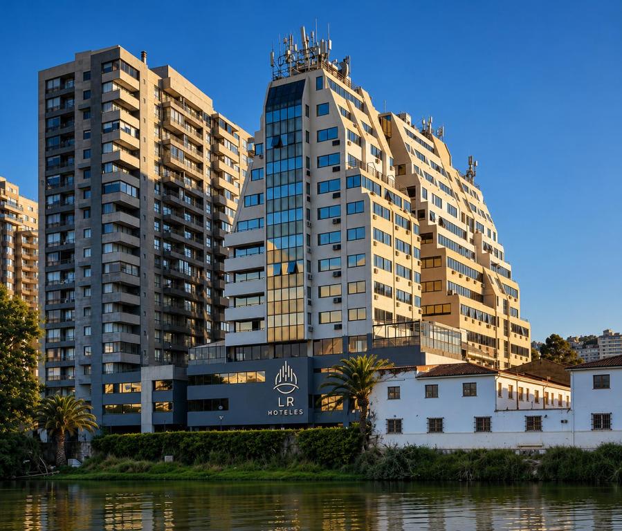 two tall buildings next to a body of water at LRH Viña del Mar and Convention Center - Ex Gala Hotel in Viña del Mar