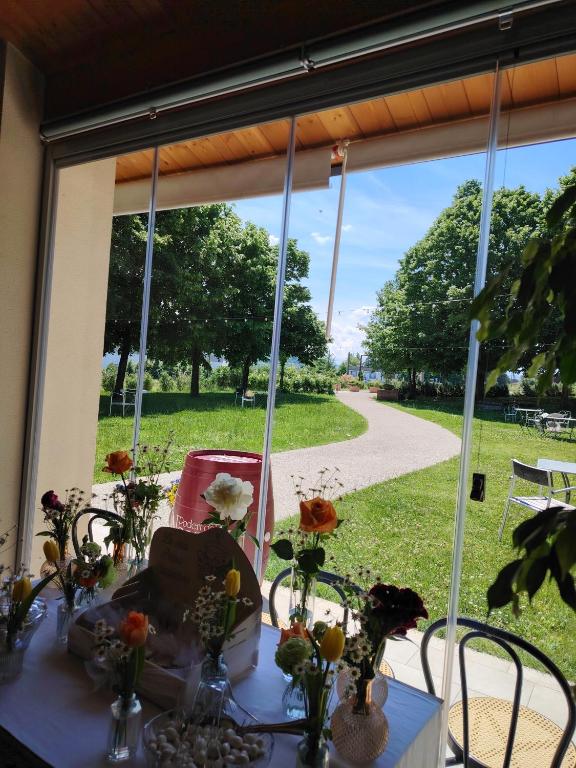 a table with flowers on it in a window at Agriturismo Casacarella in Cesena