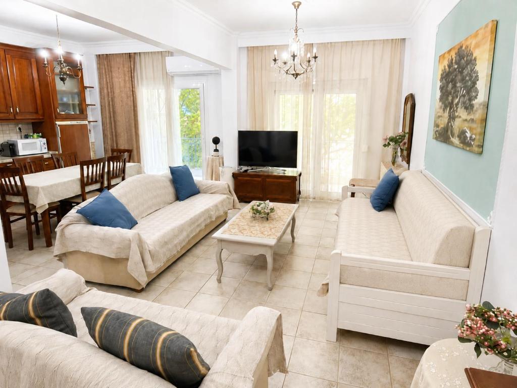 a living room with two couches and a tv at Angels' House in Thessaloniki