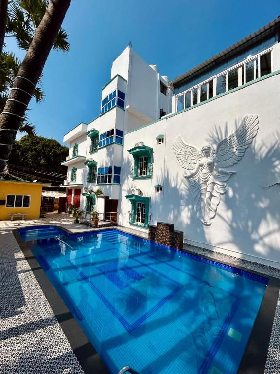 a building with a swimming pool in front of a building at LuXus Resort & Swimming Pool in Pondicherry