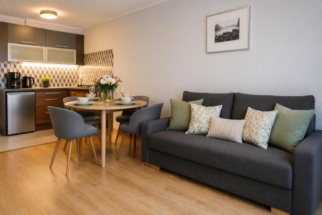 a living room with a couch and a table at Apartament Fabryczna TK in Namysłów